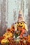 Cute scarecrow surrounded by autumn decorations