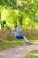 Cute school boy enjoying swing ride on playground