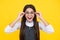 Cute school girl wearing glasses on yellow studio background, smart clever schooler girl in eyeglasses. Nerd student