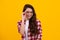 Cute school girl wearing glasses on yellow studio background, smart clever schooler girl in eyeglasses. Nerd student