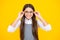 Cute school girl wearing glasses on yellow studio background, smart clever schooler girl in eyeglasses. Nerd student