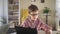 Cute schoolboy is doing homework at table with tablet during quarantine at home spbd.