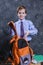 Cute schoolboy dressed in shirt and tie with schoolbag