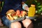 Cute schoolboy eating outdoors the school from plastick lunch boxe. Healthy school breakfast for child. Food for lunch