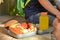 Cute schoolboy eating outdoors the school from plastick lunch boxe. Healthy school breakfast for child. Food for lunch