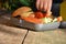 Cute schoolboy eating outdoors the school from plastick lunch boxe. Healthy school breakfast for child. Food for lunch