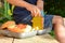 Cute schoolboy eating outdoors the school from plastick lunch boxe. Healthy school breakfast for child. Food for lunch