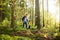 Cute schoolchild and his mature father hiking together and exploring nature. Little boy with his dad spend quality family time