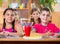 Cute schoolchildren during lesson in classroom