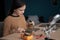 Cute schoolgirl soldering a motherboard with resistors at home using a soldering iron. Children's engineering hobby