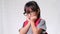 Cute schoolgirl wearing glasses with backpack , she nice-looking, charming and enjoying a good mood on white background in studio.