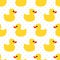 Cute seamless pattern with yellow rubber duck on polka dots background.