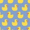 Cute seamless pattern with yellow rubber duck on wave background.