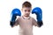Cute serious little boy with boxing gloves