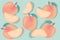 Cute set with colorful peaches cut as a seamless pattern on light emerald background