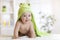 Cute seven months baby covered with green towel