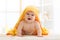 Cute seven months baby covered with yellow towel