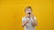 Cute shocked surprised little boy toddler on isolated yellow background