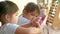 Cute sibling child girls learning with educational colorful wooden abacus and counting indoors. Home school of preschool children