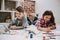 Cute Siblings Drawing Pictures Laying at Floor