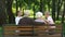 Cute siblings running to grandparents sitting on bench in public park, family