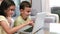 Cute siblings using laptop in the living room