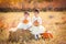 Cute sisters holding pumpkins