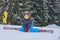 Cute skier boy in a winter ski resort.