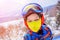 Cute skier boy in a winter ski resort.