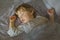 Cute sleeping baby. Children`s Daytime sleeping. The Little Caucasian Boy sleeping on stomach in a big bed under a blanket. Close