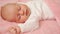Cute sleeping baby under pink blanket. mode of day, healthy sleep in newborns