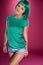 Cute slender young woman with green hair