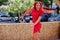 Cute and slim african american girl in red dress with dreadlocks