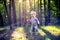 Cute small child in forest at sunset light