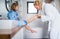 A cute small girl with mother in bathroom indoors at home, painting nails.