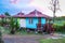 Cute Small Green and Blue Cottage in the Evening