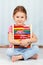 Cute and smart preschool girl holding abacus