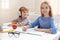 Cute smart siblings studying together