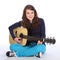 Cute smile by teenager girl on acoustic guitar