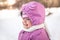 Cute smiling baby portrait in warm clothes in cold sunny winter day