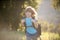 Cute smiling boy with hiking backpack in the mountains. Child hiker hike in hills background.