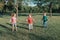 Cute smiling Caucasian preschool girl boys friends playing with hoola hoop in park outside. Kids sport activity. Lifestyle happy