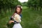 Cute smiling girl with a bouquet of daisies and a flower in the hair. girl with a bunch of chamomiles