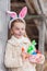Cute smiling girl in a hare mask for the celebration of the International Easter Day
