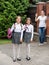 Cute smiling girls leaving home for school at morning