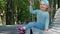 Cute smiling little girl in blue clothes joyfully shows her age on her fingers