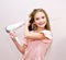 Cute smiling little girl child drying her long hair with hair dryer