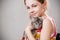 Cute smiling little girl holds funny gray chinchilla.