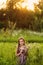 Cute smiling little girl on the meadow at the farm. Portrait of adorable small kid outdoor