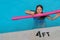 Cute smiling little girl in summer vacation swimming pool